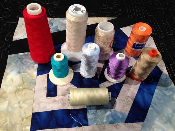 Cross wound thread - Left to Right Back Row: Serger Thread